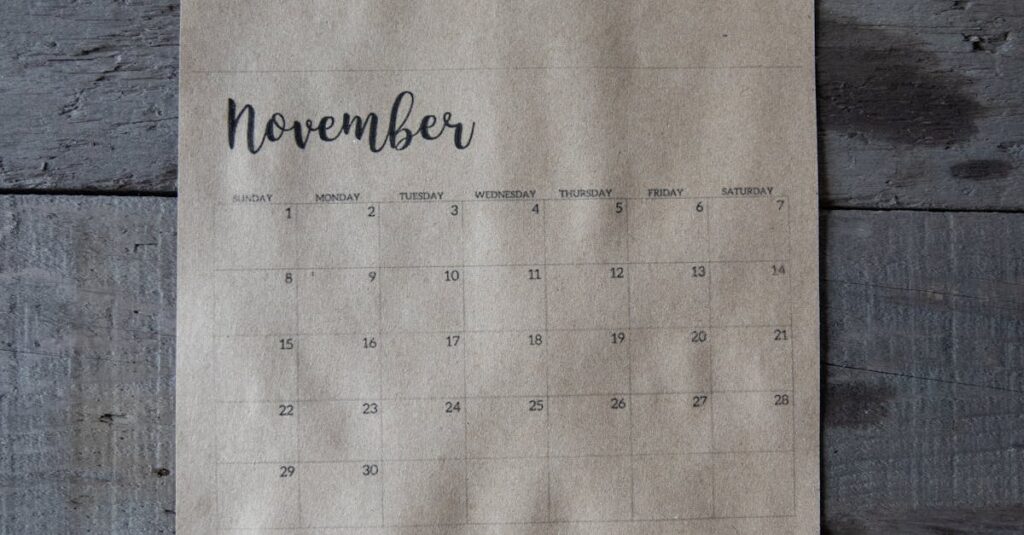 A vintage-style November calendar page on a rustic wooden background.
