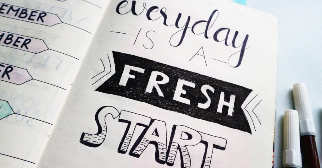 Notebook page featuring motivational quote 'Everyday is a fresh start' with colorful pens.