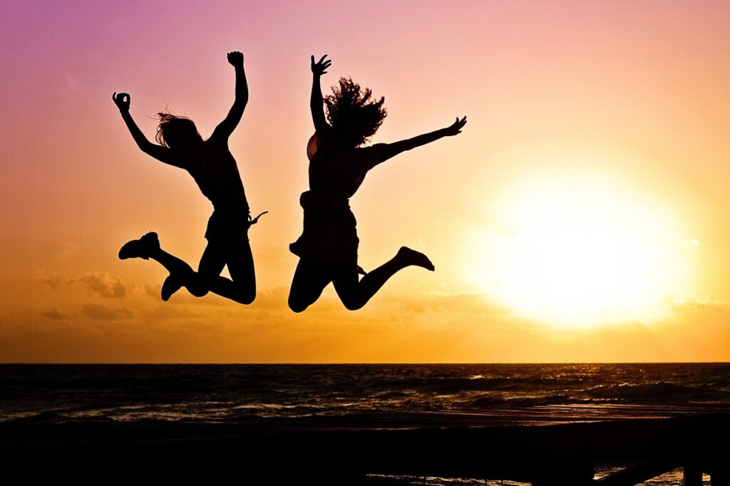 new year background, sunset, beach, silhouettes, jump, jumping, youth, active, happy, pair, girls, young women, people, joy, freedom, seaside, nature, dusk