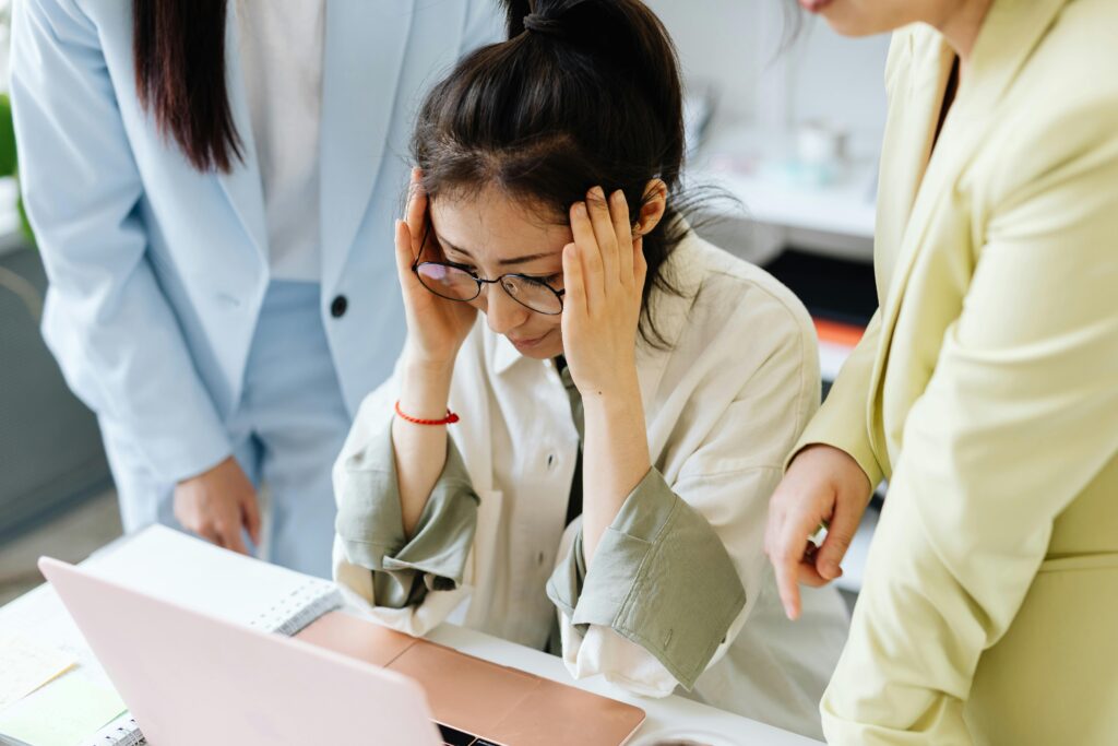 Team of businesswomen focused on solving a challenging work problem in an office setting.